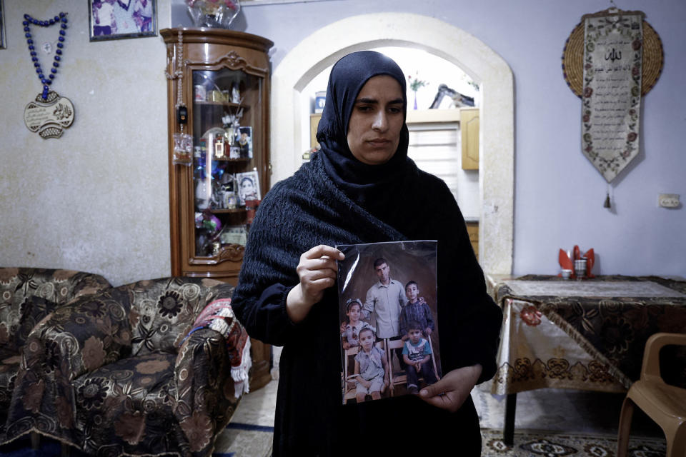 The wife of Palestinian Bilal Saleh shows a picture her late husband in the West Bank village of As-Sawiyah on Nov. 29, 2023. (Kenzo Tribouillard / AFP via Getty Images)