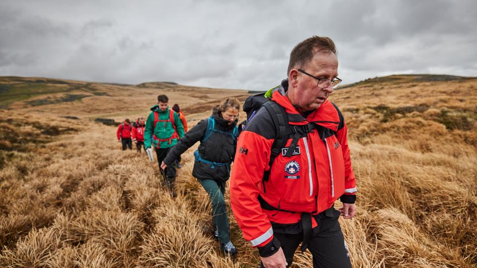 Mountain rescue leading a team of hikers