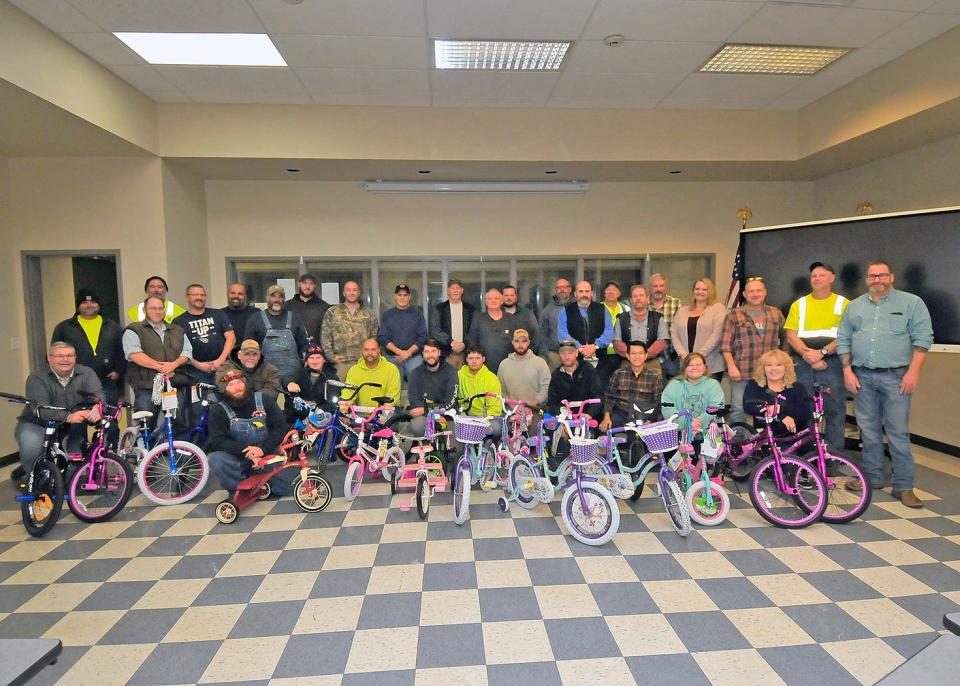 Wayne County Engineer's Office employees pose with the bikes they purchased and assembled. The bikes will be donated to the Fraternal Order of the Police for the annual Shop with a Hero event and OneEighty.