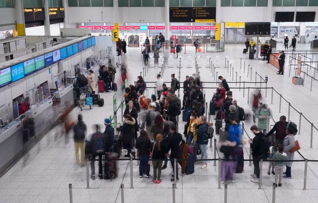 Passengers check-in at the South Terminal of Gatwick Airport in West Sussex 