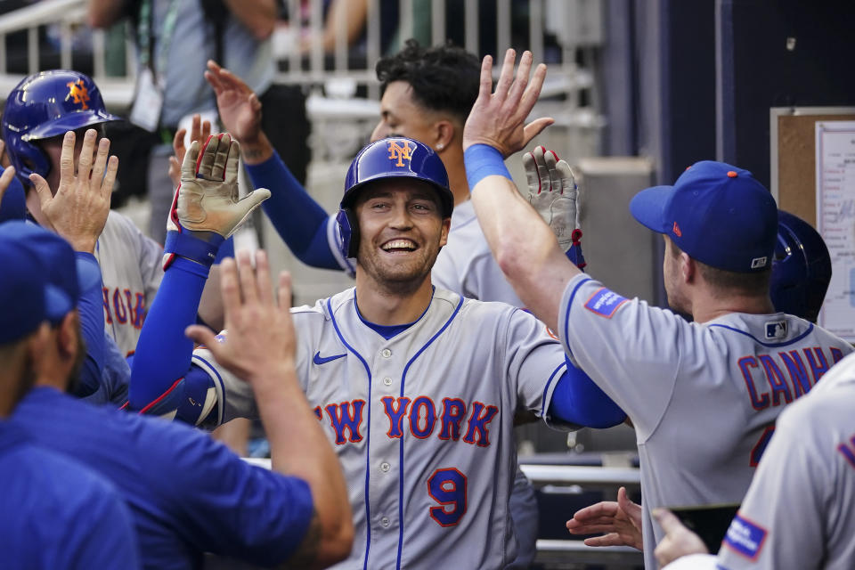 New York Mets center fielder Brandon Nimmo (9) celebrates in the dugout after hitting a grand slam in the second inning of a baseball game against the Atlanta Braves, Thursday, June 8, 2023, in Atlanta. (AP Photo/John Bazemore)