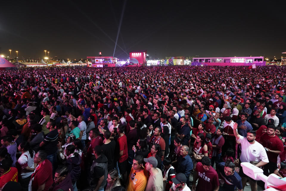 Fans watch the group A soccer match between Qatar and Ecuador in Doha, Qatar, Sunday, Nov. 20, 2022. (AP Photo/Moises Castillo)