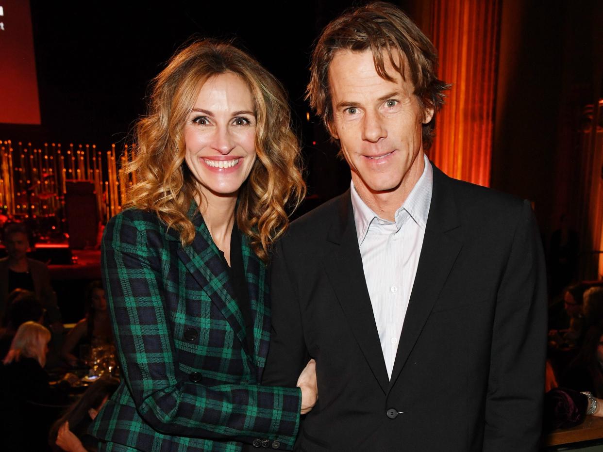 Julia Roberts wears a green plaid suit and poses next to husband Daniel Moder.