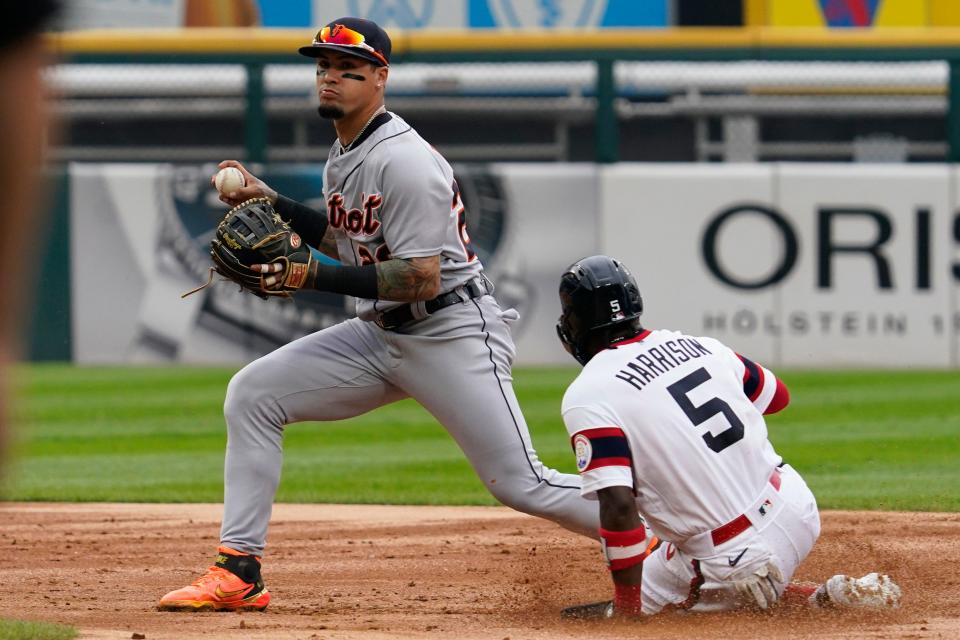 Tigers shortstop Javier Baez, left, forces out White Sox's Josh Harrison (5) at second base during the second inning of a baseball game in Chicago, Sunday, Aug. 14, 2022. White Sox's Adam Engel (not pictured) was safe at first base.