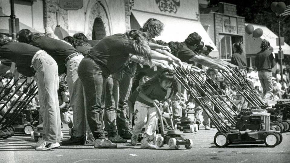 April Sosa, 7, leads the Minor Miners during an exercise on Saturday by the Miner’s Hardware Lawnmower Drill Team at the Arroyo Grande Harvest Festival in 1992.