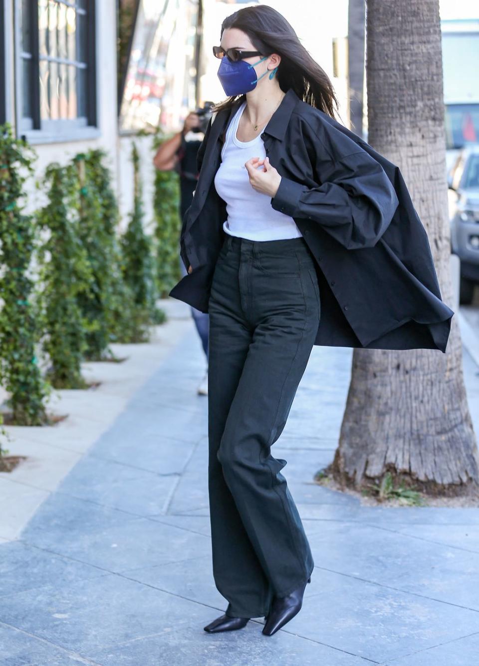 <p>Jenner was spotted out and about dressed in a menswear-inspired look on February 3.</p><p>The model kept things simple in an oversized black menswear shirt, layered over a white tank top and high-rise dark jeans. </p><p>In typical Jenner style, the fashion didn't stop there, as she effortlessly accessorised her outfit with dark, tinted, retro shades and square toe boots. </p>