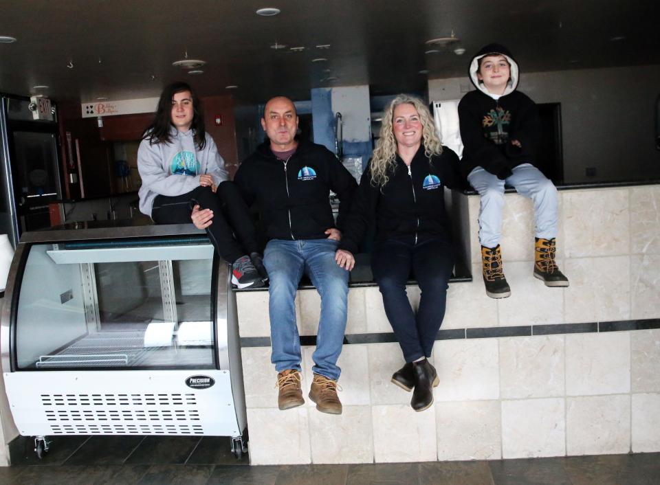 Stephanie Bergeron and Coskun Yazgan smile with their kids Didi, 11, and Baris, 8, as they prepare to launch their new cafe at Hampton Beach this spring.