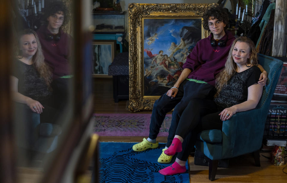 Carey Johnson and her son Fabian Swain are photographed in their Germantown, Md., home on Monday, Nov. 14, 2022. Both Carey and Fabian have recovered from COVID. (AP Photo/Carolyn Kaster)