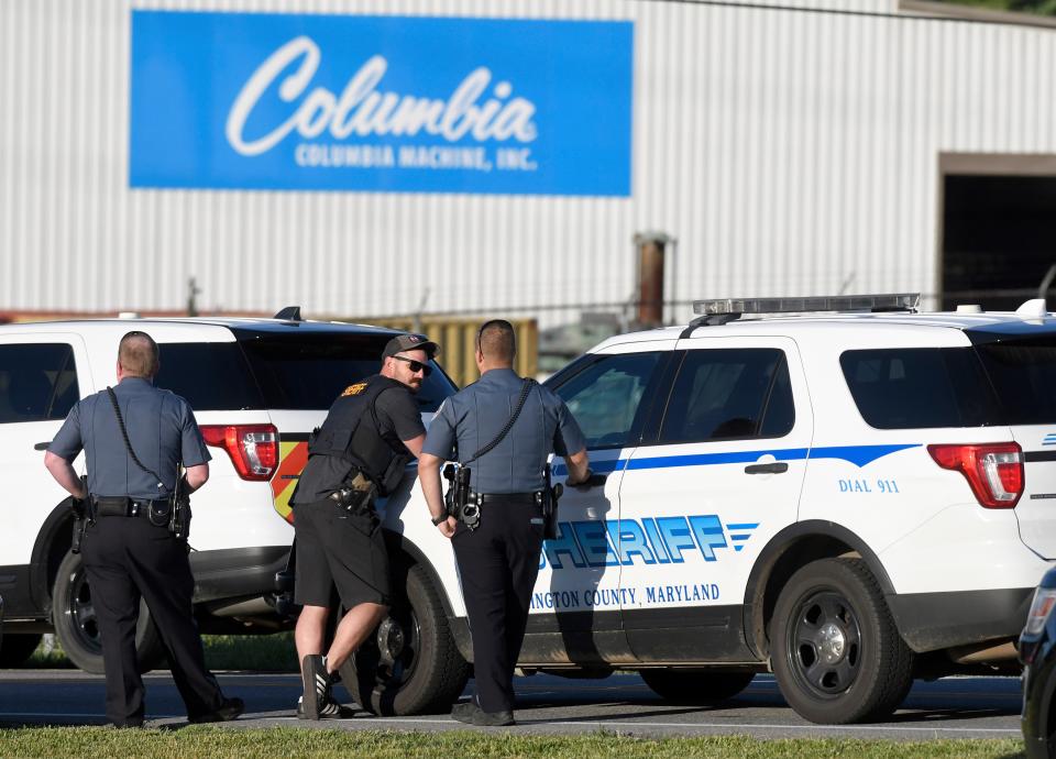 Police stand near where a man opened fire at a business, killing three people before the suspect and a state trooper were wounded in a shootout, according to authorities, in Smithsburg, Md., Thursday, June 9, 2022. The Washington County (Md.) Sheriff's Office said in a news release that three victims were found dead at Columbia Machine Inc. and a fourth victim was critically injured. (AP)