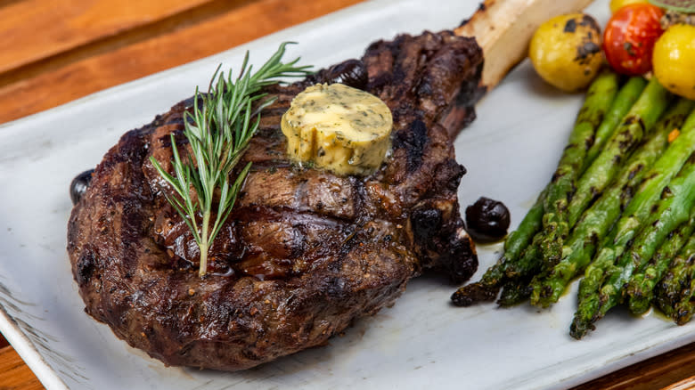 Grilled tomahawk steak with vegetables