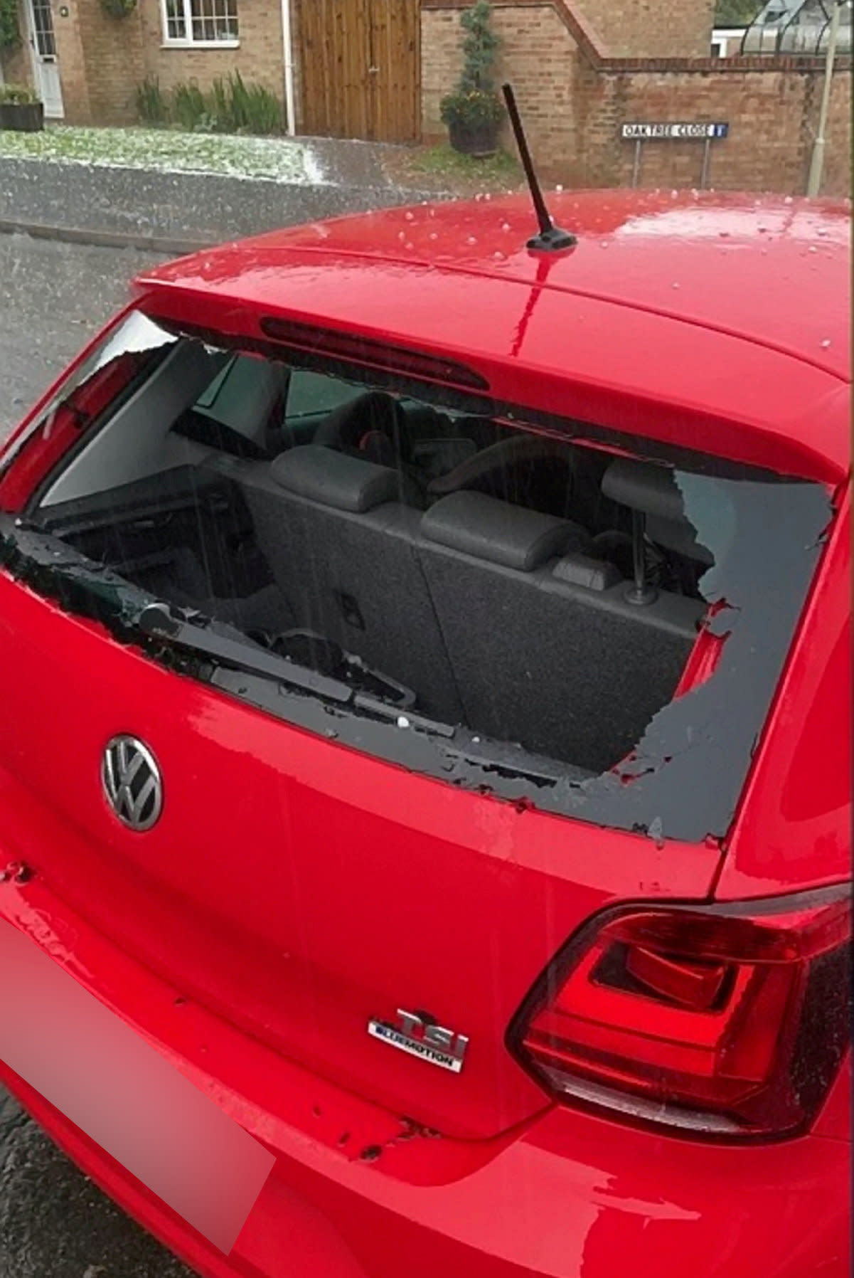 Kevin Messenger's car that had it's window smashed in a hail storm.  Hail the size of golf balls fell in a thunderstorm damaging cars and smashing windows as extreme heat warnings stayed in place across England.  The hail storm hit Leicestershire around 18.15 BST, July 20, 2021, with some car windows obliterated.  See SWNS story SWMDhail.  July 21, 2021. 