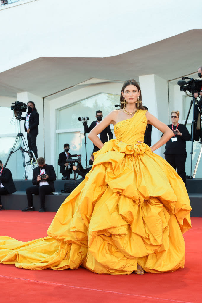 Bianca Balti in a flowing, bunched bright yellow gown on the red carpet for "Madres Paralelas"