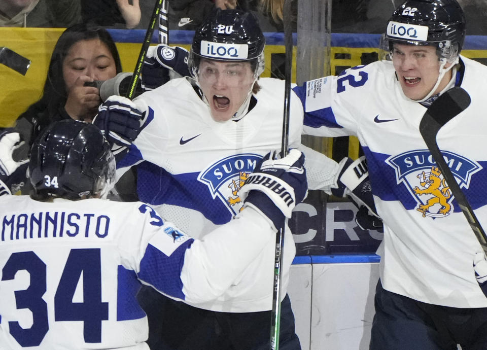 Finland's Oiva Keskinen (20) celebrates his goal with teammates Tommi Mannisto (34) and Kasper Halttunen (22) during the first period of a semifinal hockey game against the United States at the IIHF World Junior Hockey Championship in Gothenburg, Sweden, Thursday Jan. 4, 2024. (Christinne Muschi/The Canadian Press via AP)
