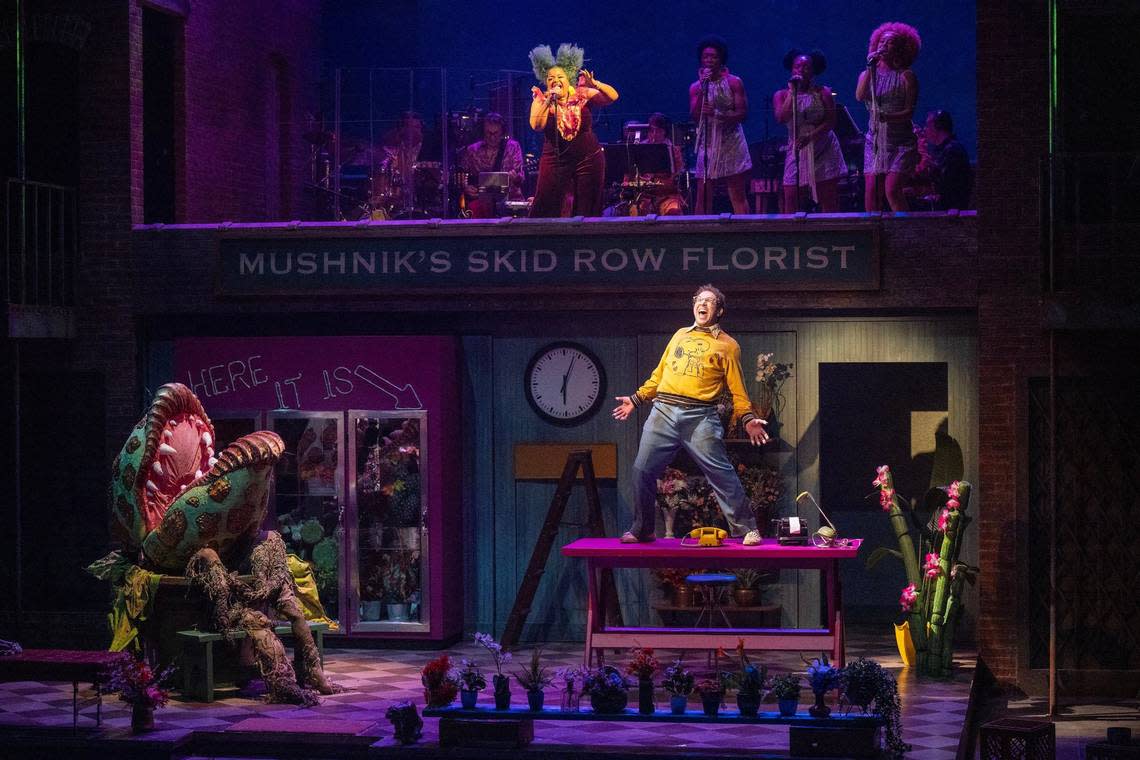 On the upper stage, Shon Ruffin, top, performs as the voice of Audrey II while Jordan Matthew Brown performs as Seymour in “Little Shop of Horrors.”