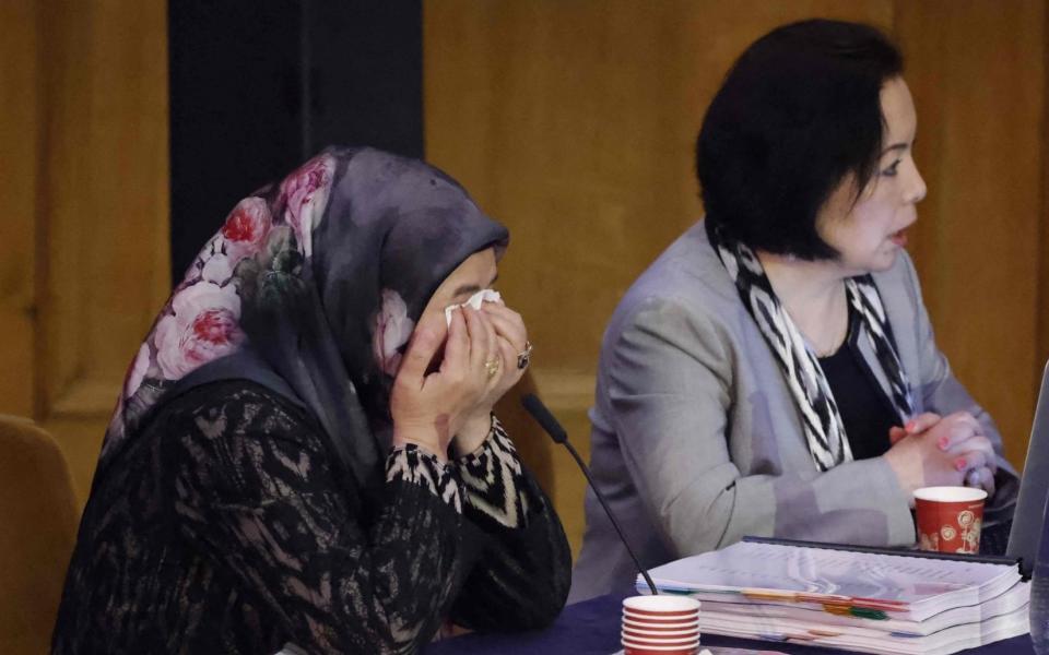 Witness Patigul Talip (L) reacts as she speaks on the first day of hearings at the "Uyghur Tribunal", a panel of UK-based lawyers and rights experts investigating alleged abuses against Uyghurs in China, in London on June 4, 2021. - The panel, which has no state backing, will begin hearing evidence from witnesses on Friday, and plans to issue a verdict on whether Beijing has perpetrated genocide or crimes against humanity against Uyghurs and other Muslim groups in China. Beijing has branded it a "machine producing lies".  - Tolga Akmen/AFP via Getty Images