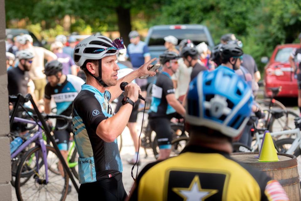 Clark Butcher, owner of Victory Bicycle Studio, addresses a group of riders during a large group ride. Victory organizes group rides every Sunday throughout the summer.