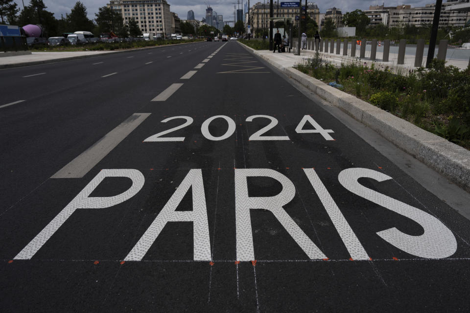 An Olympic priority lane is seen near the Paris 2024 media center, Wednesday, July 3, 2024 in Paris. The Olympic and Paralympic lanes will be activated from July 15th and will be reserved for vehicles accredited by Paris 2024 in some areas of Paris and it rings. (AP Photo/Louise Delmotte)