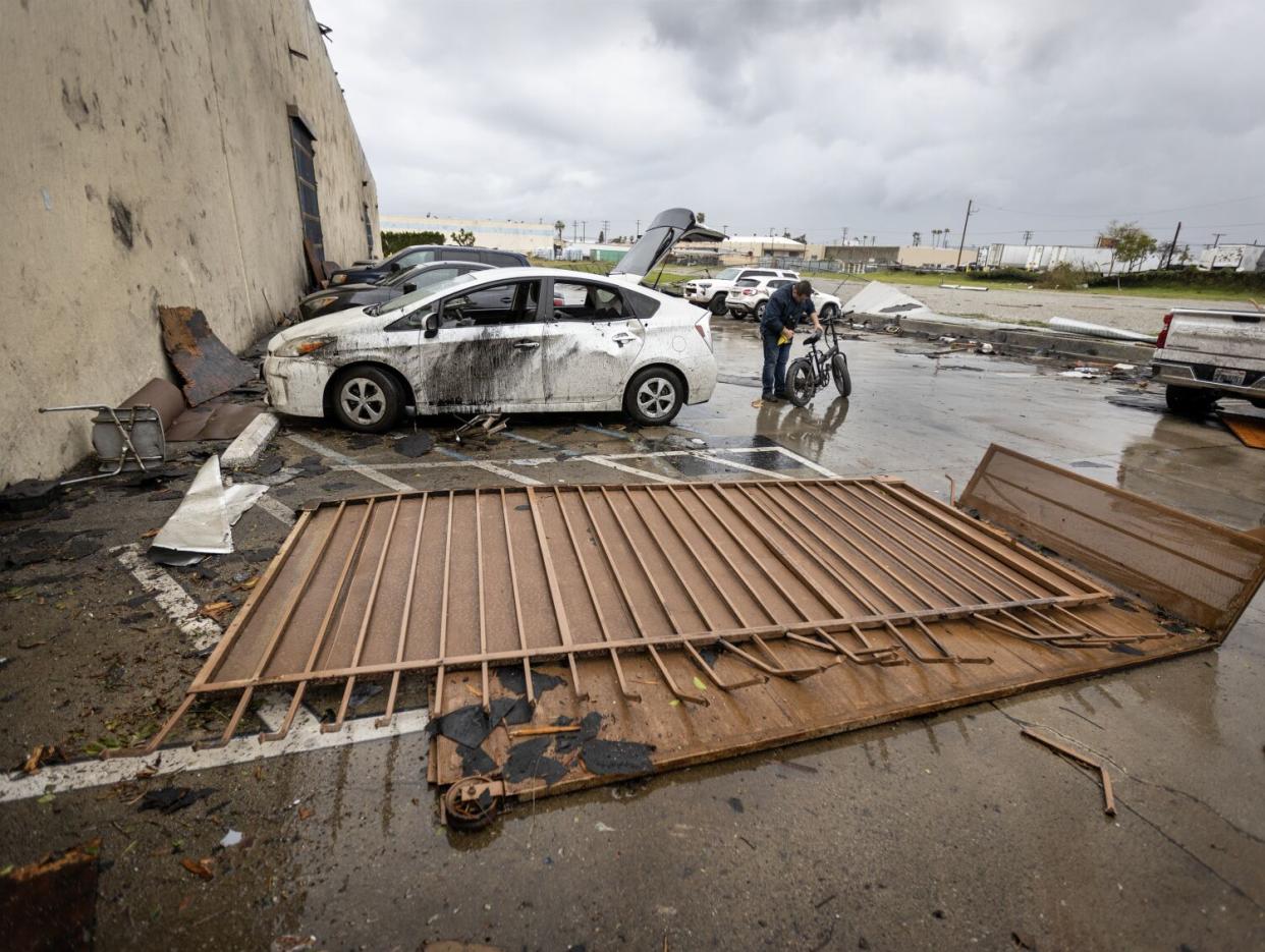 An employee removes his bike from his damaged car