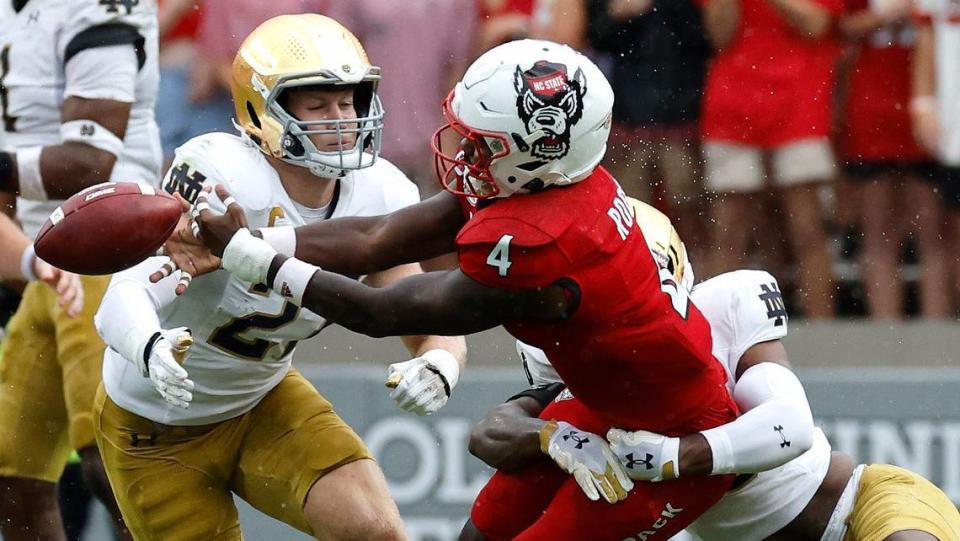 N.C. State wide receiver Porter Rooks (4) can’t pull in the pass while defended by Notre Dame safety Thomas Harper (13) during the first half of N.C. State’s game against Notre Dame at Carter-Finley Stadium in Raleigh, N.C., Saturday, Sept. 9, 2023.