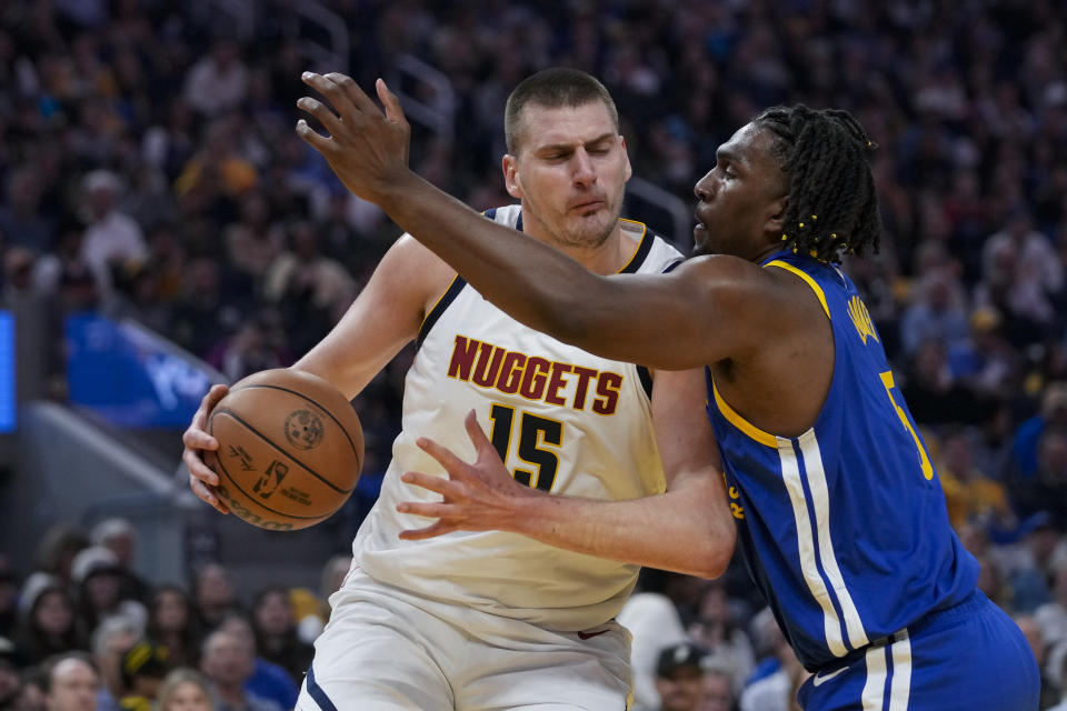 Denver Nuggets center Nikola Jokic, left, tries to get around Golden State Warriors center Kevon Looney during the first half of an NBA basketball game Sunday, Feb. 25, 2024, in San Francisco. (AP Photo/Godofredo A. Vásquez)