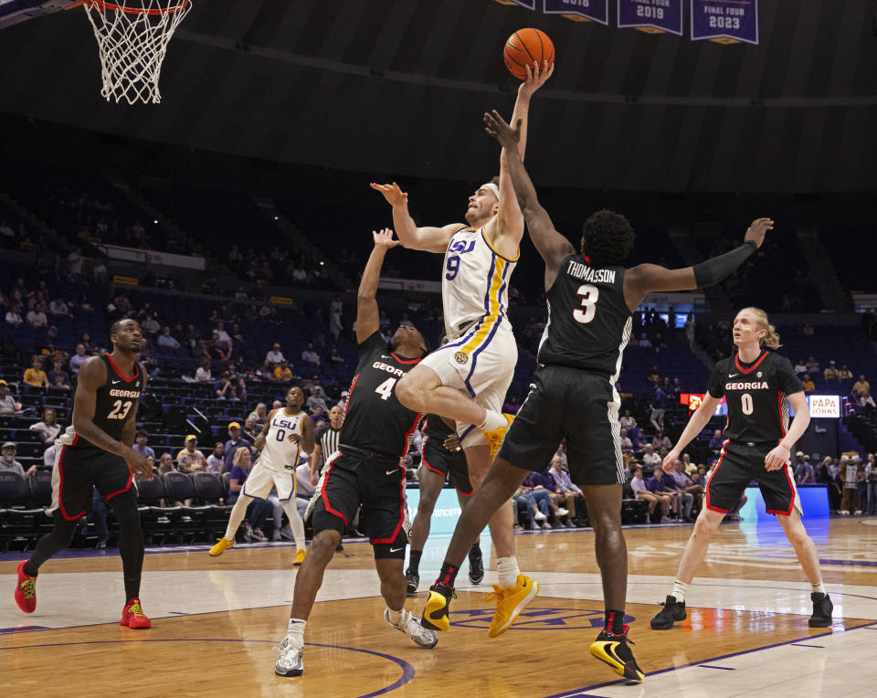 LSU forward Will Baker (9) drives to the basket past Georgia guard Silas Demary Jr. (4) and guard Noah Thomasson (3) during an NCAA college basketball game Tuesday, Feb. 27, 2024, in Baton Rouge, La. (Hilary Scheinuk/The Advocate via AP)