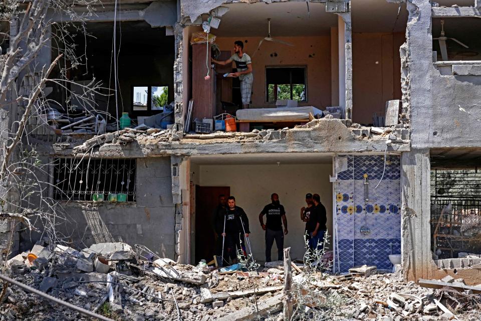 Palestinians assess the damage from an Israeli airstrike to a building in Beit Hanun in the northern Gaza Strip on May 14.