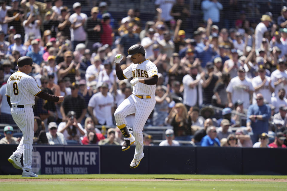 San Diego Padres' Juan Soto, right, celebrates alongside third base coach Mike Shildt (8) after hitting a home run during the fourth inning of a baseball game against the Atlanta Braves, Wednesday, April 19, 2023, in San Diego. (AP Photo/Gregory Bull)