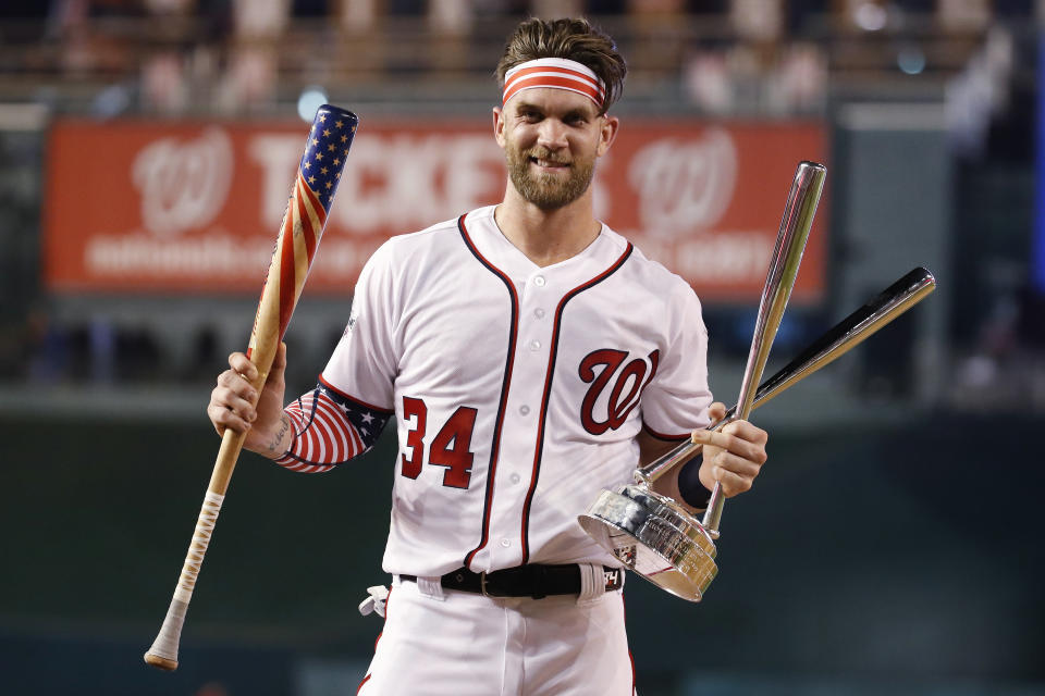 Washington Nationals Bryce Harper (34) holds his bat and the trophy after winning the Major League Baseball Home Run Derby Monday, July 16, 2018 in Washington. (AP)