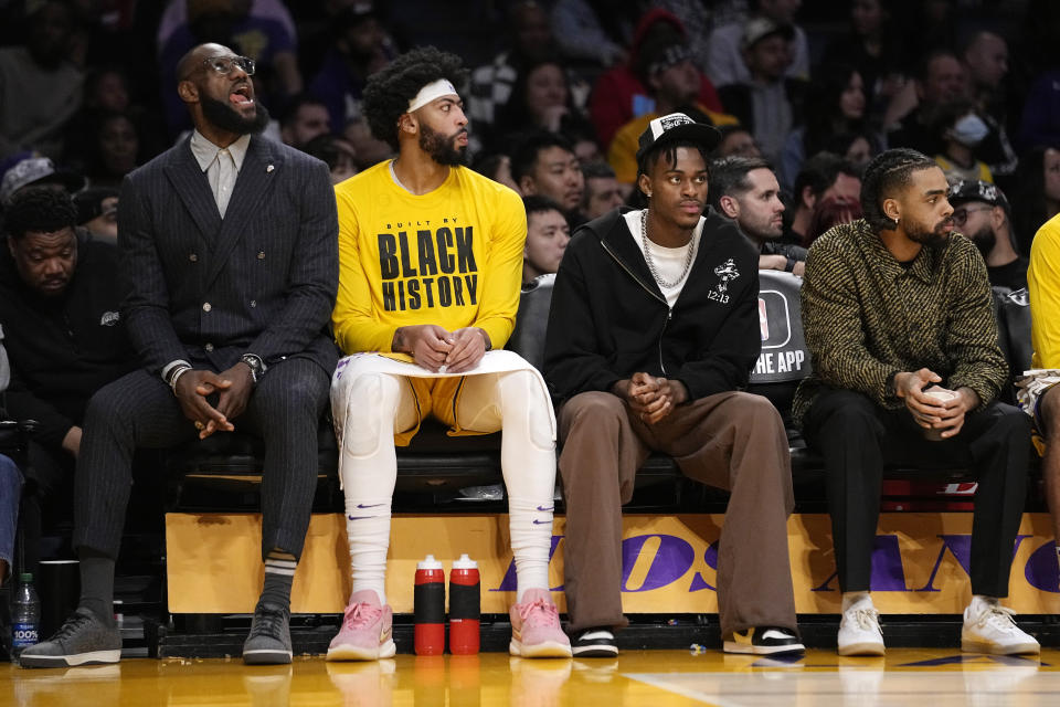Los Angeles Lakers' LeBron James, left, sits on the bench with forward Anthony Davis, second from left, Jarred Vanderbilt and D'Angelo Russell during the second half of an NBA basketball game against the Milwaukee Bucks Thursday, Feb. 9, 2023, in Los Angeles. (AP Photo/Mark J. Terrill)