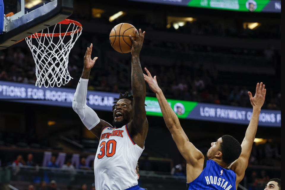 New York Knicks forward Julius Randle (30) misses a slam as he is defended by Orlando Magic guard Caleb Houstan, right, during the first half of an NBA basketball game, Thursday, March 23, 2023, in Orlando, Fla. (AP Photo/Kevin Kolczynski)