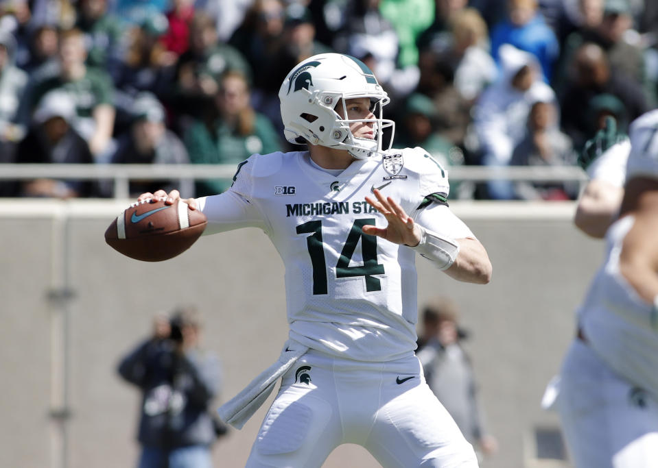 Michigan State quarterback Brian Lewerke looks to throw a pass during an NCAA college football spring scrimmage game, Saturday, April 13, 2019, in East Lansing, Mich. (AP Photo/Al Goldis)