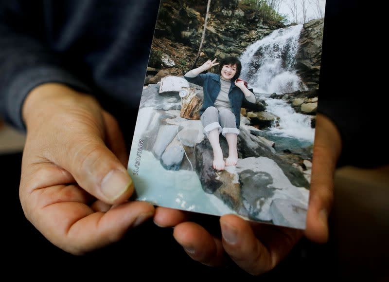 The Wider Image: Japan's tsunami survivors call lost loves on the phone of the wind