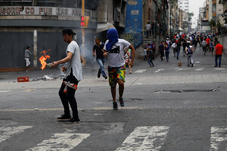 Demonstrators take part in a protest against the government of Venezuelan President Nicolas Maduro in Caracas, Venezuela March 31, 2019. REUTERS/Carlos Garcia Rawlins