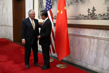 U.S. Secretary of State Rex Tillerson (L) talks with Chinese Foreign Minister Wang Yi, as he arrives for a bilateral meeting at the Diaoyutai State Guesthouse in Beijing, China, Saturday, March 18, 2017.REUTERS/Mark Schiefelbein/Pool