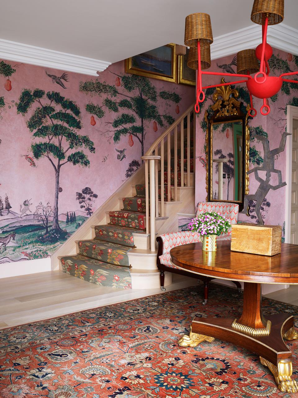 In the entry, flat-weave rugs were fashioned into a stair runner, antique mirror.