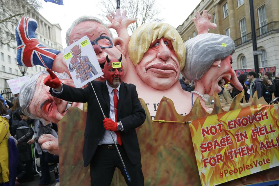 Effigies of British Prime Minister Theresa May and Conservative politicians Boris Johnson and Michael Gove, from right, and displayed during a Peoples Vote anti-Brexit march in London, Saturday, March 23, 2019. Anti-Brexit protesters swarmed the streets of central London by the tens of thousands on Saturday, demanding that Britain's Conservative-led government hold a new referendum on whether Britain should leave the European Union. (AP Photo/Kirsty Wigglesworth)