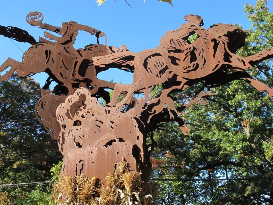 In this Oct. 18, 2013 photo, an 18-foot-tall sculpture depicting the climax of "The Legend of Sleepy Hollow" stands in Sleepy Hollow, N.Y. The village of Sleepy Hollow is even busier than usual this Halloween, thanks to a new "Sleepy Hollow" TV series inspired by the tale of the Headless Horseman. (AP Photo/Jim Fitzgerald)