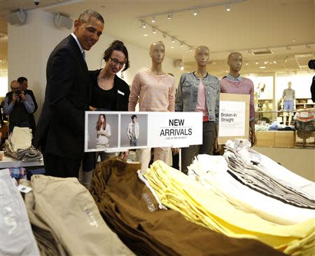 U.S. President Barack Obama looks for gifts for his family with saleswoman Susan Panariello after stopping off at the GAP in New York, March 11, 2014. REUTERS/Larry Downing