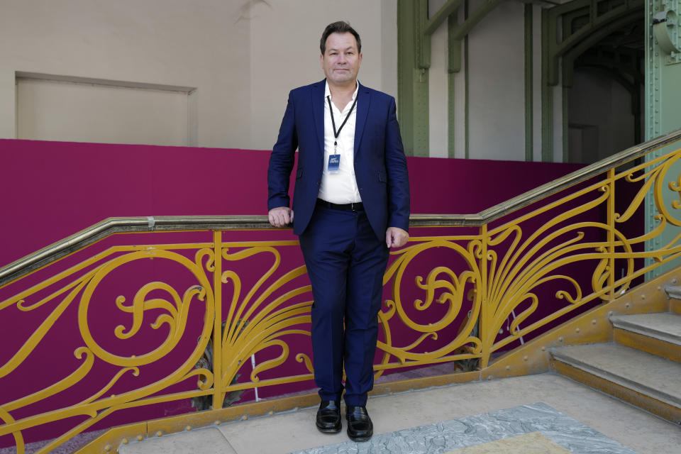 Art Paris General Curator Guillaume Piens, poses during the private view of Art Paris at the Grand Palais in Paris, Wednesday Sept. 9, 2020. The coronavirus pandemic has led to the cancellation of this year's premiere global art fairs, stymieing the main commercial artery of the multibillion-dollar industry. But Art Paris, which is France's second-biggest contemporary art fair, is opening its doors to thousands of visitors from Thursday in the Grand Palais. The four-day show is going ahead despite a spike in COVID-19 infections in the country. Art Paris is the first big international art fair to physically go ahead since the coronavirus swept through the world, grounding flights, triggering lockdowns and devastating commerce. (AP Photo/Francois Mori)