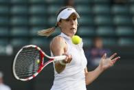 Alize Cornet of France hits a return during her women's singles tennis match against Serena Williams of the U.S. at the Wimbledon Tennis Championships, in London June 28, 2014. REUTERS/Stefan Wermuth (BRITAIN - Tags: SPORT TENNIS)