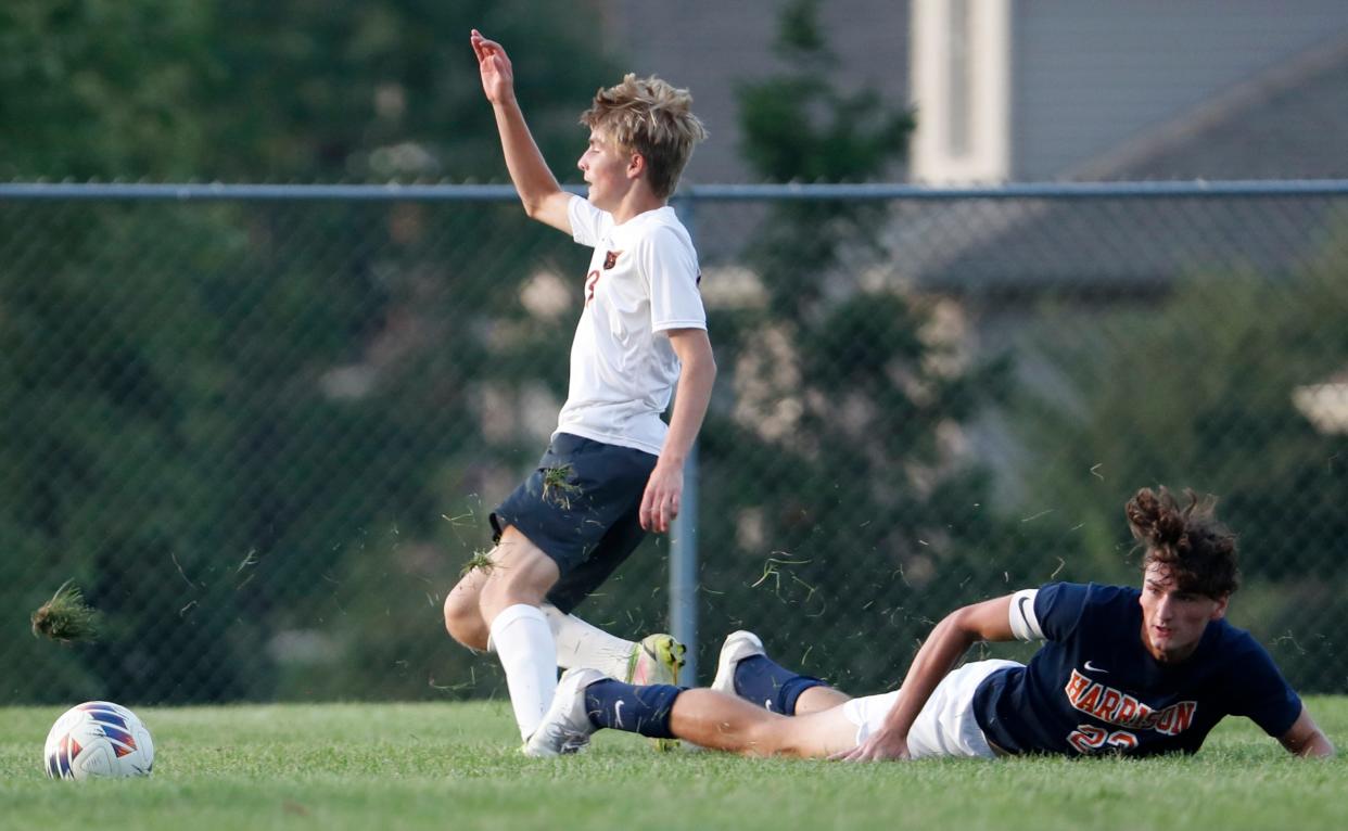 McCutcheon Mavericks Korbin Vanette (19) is slide tackled by Harrison Raiders Gavin Knoth (22) during the IHSAA boy’s soccer game, Tuesday, Aug. 29, 2023, at Harrison High School in West Lafayette, Ind. Harrison won 6-0.