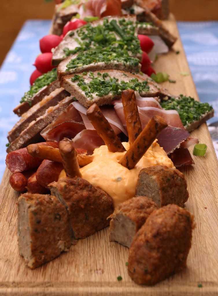 Typical Bavarian food is pictured at a beer tent on the opening day of the Oktoberfest 2012 beer festival. The festival also sees the copious consumption of traditional food such as chicken, roast pork, grilled ham hock, grilled fish on sticks, sausages and pretzels, potato and bread dumplings, cheese noodles, potato pancakes and Sauerkraut or red cabbage. Also in demand are Bavarian delicacies such as Obatzda (a spiced spread of cheese and butter) and the white sausage known as Weisswurst.