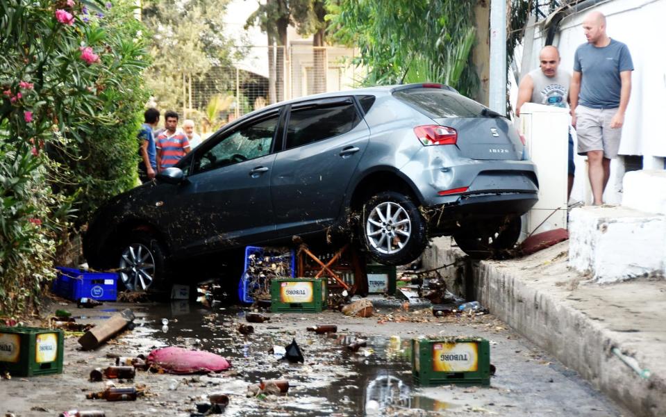 a damaged car following a sea surge caused by an earthquake, in the Agean coastal city of Mugla - Credit: DOGAN NEWS AGENCY