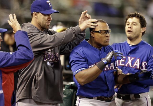 Adrian Beltre Jr., left, runs up to his father Texas Rangers