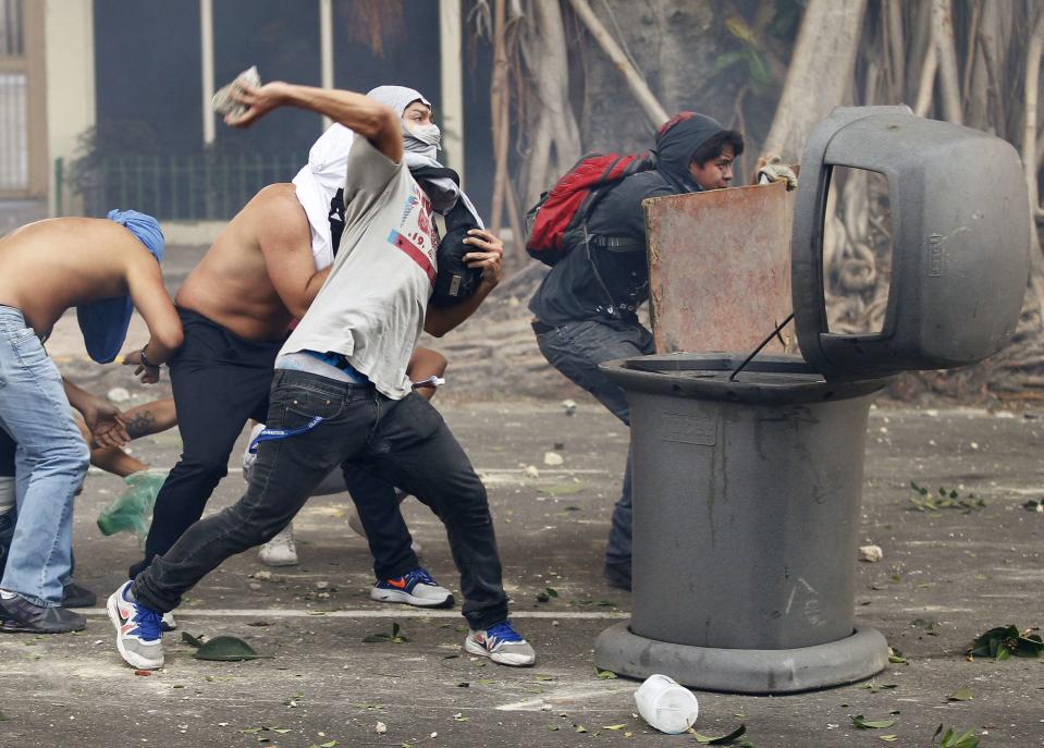 Demonstrators confront police as they protest against the government of President Nicolas Maduro in Caracas