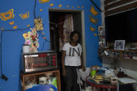 Geisa Rodrigues dos Santos, a house cleaner and mother of three, poses for a photo inside her home on occupied land in Rio de Janeiro, Brazil, Monday, June 20, 2022. “Back then in the pandemic the handouts worked. They saved a lot of mothers,” said dos Santos, 35. “Now, I spend these 400 reais ($77) at the supermarket and inflation eats a large part of it. During the Lula days, we ate.” She didn’t vote in 2018, but now intends to vote for former President Luiz Inacio Lula da Silva in the Oct. 2 election. (AP Photo/Silvia Izquierdo)