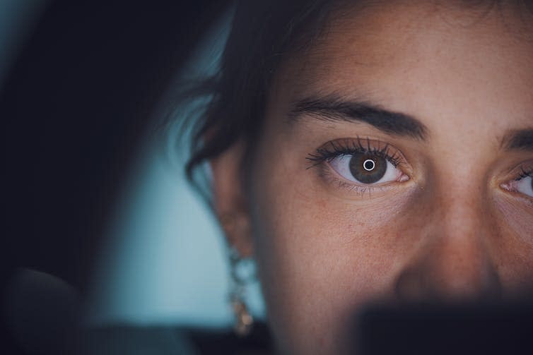 Close up of a young woman's face, one eye and nose are in frame.