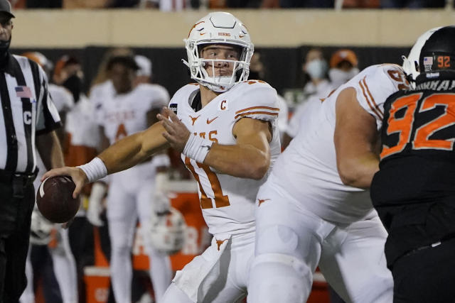 Texas quarterback Sam Ehlinger (11) is stopped by Oklahoma State