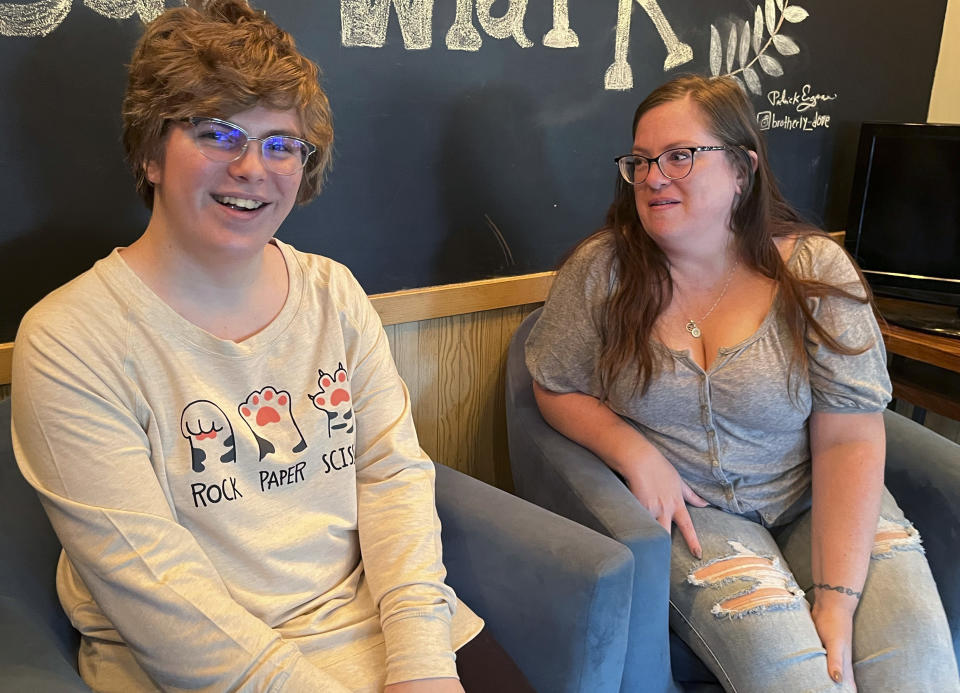 Nola Rhea, 17, left, and her mother, Heather Rhea, 47, sit together in a coffee shop on Sept. 26, 2023, in Lincoln, Neb., as they discuss Nola's plans to leave the state of Nebraska next year to attend college following the state's enactment of a law restricting gender-confirming medical treatments for minors. Nola is a transgender teen who says she no longer feels welcomed in Nebraska. (AP Photo/Margery Beck)