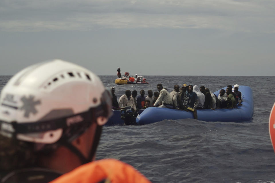 Migrants aboard an unseaworthy rubber boat wait to be rescued some 14 nautical miles from the coast of Libya in Mediterranean Sea, Sunday, Sept. 8, 2019. Humanitarian groups SOS Mediterranee and Doctors Without Borders have successfully rescued 50 migrants and brought them aboard the Ocean Viking. (AP Photo/Renata Brito)